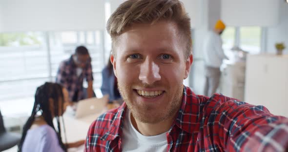 Hipster Guy Streaming Video Online Working in Creative Office
