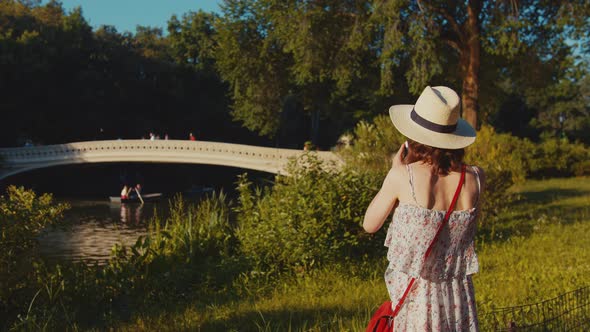 Young photographer in Central Park in summer