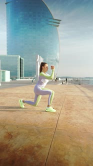 Female Athlete Squatting on Embankment