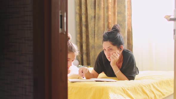 Mother With Child Do Homework At Home