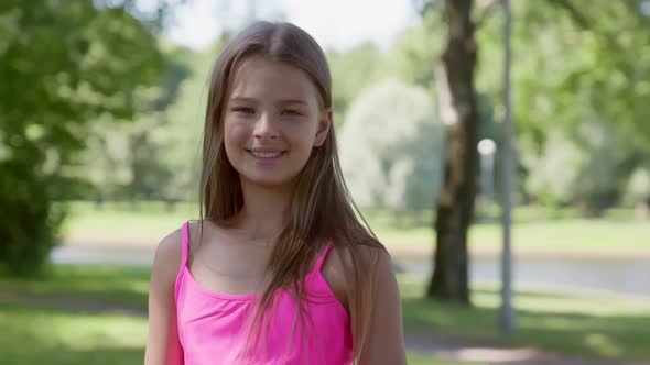 Medium Shot of Adorable Smiling Teen Girl Outdoors