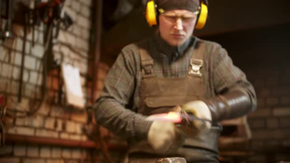 Blacksmith Forging a Knife in Workshop
