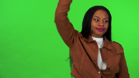 A Young Black Woman Smiles and Dances - Green Screen Studio