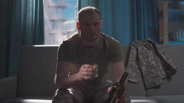 Portrait Professional Military Man Sits in Depression and Frustration with Alcohol and Drinks