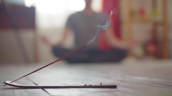 Steaming Incense Stick Closeup on the Floor