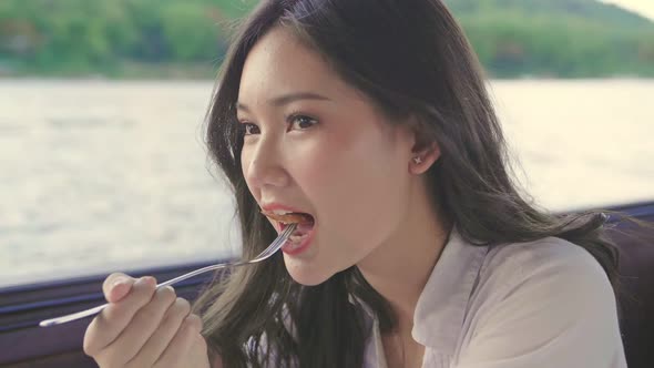 Beautiful Asian Woman Eating Food