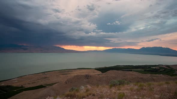 Dark storm clouds rolling through valley over Utah Lake