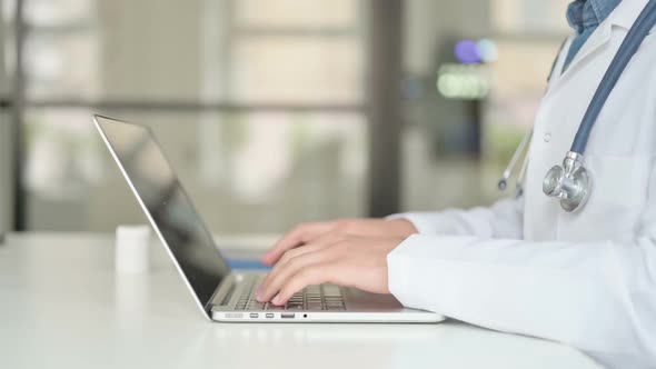 Close Up of Doctor Working on Laptop