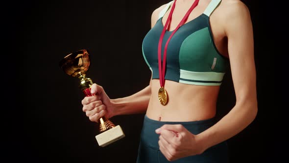 Professional Sportswoman Winner Holding Gold Cup Golden Medal Closeup