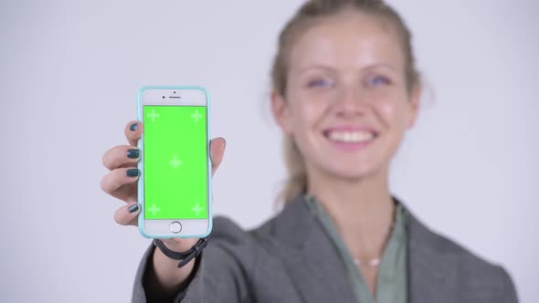 Face of Young Happy Blonde Businesswoman Showing Phone