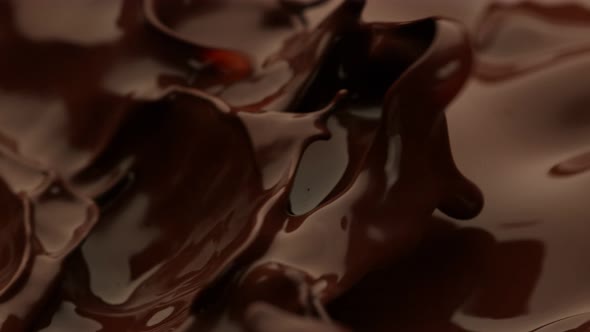 Super Slow Motion Detail Shot of Waving and Splashing Melted Chocolate at 1000 Fps