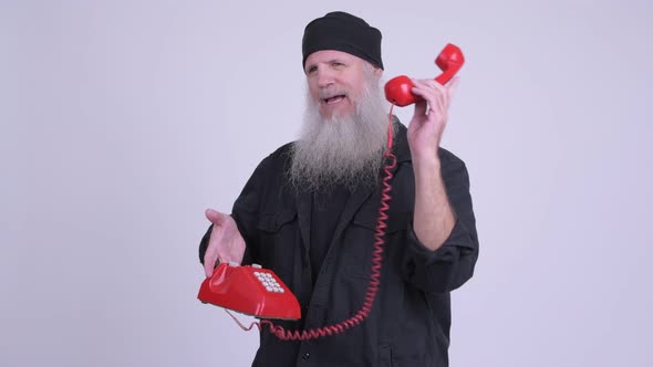Happy Mature Bearded Hipster Man Talking on the Phone