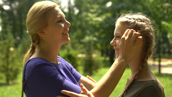 Mother Looking at Her Pretty Daughter With Love and Tenderness