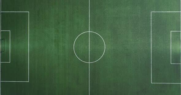 Aerial view of green football, soccer pitch. Top down view on a green, empty soccer field