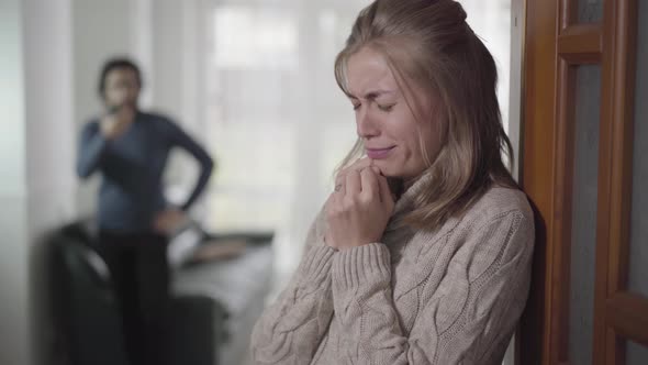Close-up Face of Exhausted Caucasian Woman Standing with Pregnancy Test, and Crying