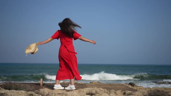 Excited Happy Woman in Red Dress Spinning in Slow Motion Enjoying Summer Vacations on Cyprus