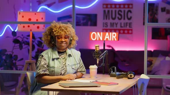 Portrait of Female African American Podcast Host in Studio