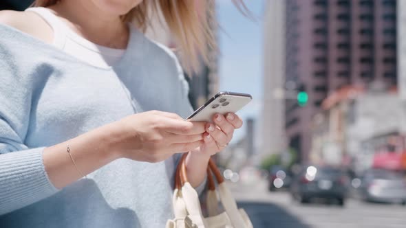 Successful Young Woman Browsing Online Smartphone in Central Business District