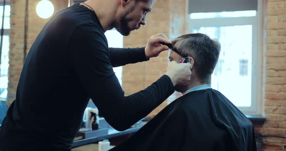 Barber Cuts the Hair of the Client to the Machine