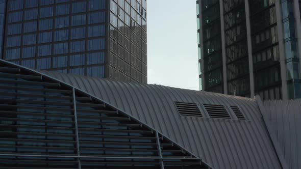 AERIAL: Close Up View of Skyscraper Construction Site in Urban Environment with City Car Traffic and