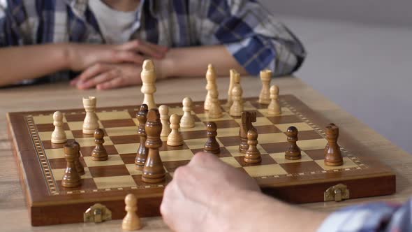 Father Playing Chess With Little Son at Home, Brain Development Activity Closeup