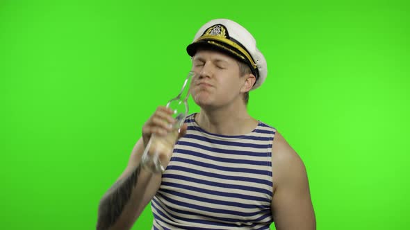 Young Sailor Man Drinks Vodka. Seaman Guy in Sailor's Vest Shirt. Chroma Key