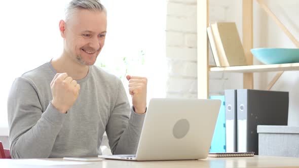 Excited Middle Aged Man Celebrating Success of Work