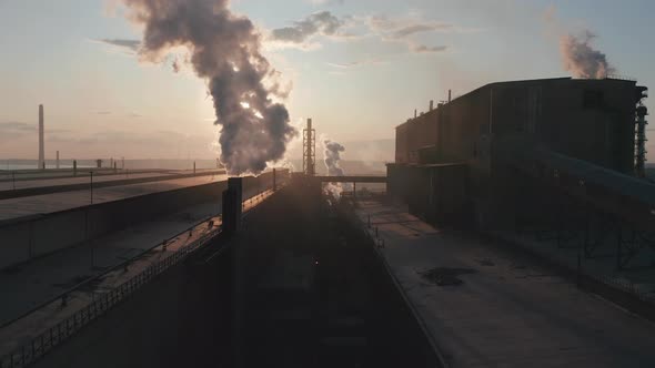 Aerial View. Industrial Zone with Pipe Thick White Smoke Is Poured From the Factory Pipe in Contrast