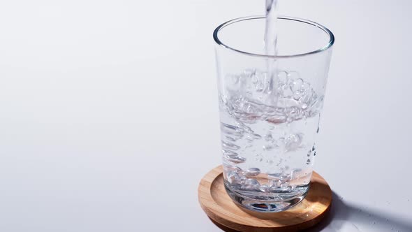 Pure Water Poured Into Glass Closeup with Slow motion