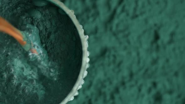 Glass of milk with spirulina powder view from the top