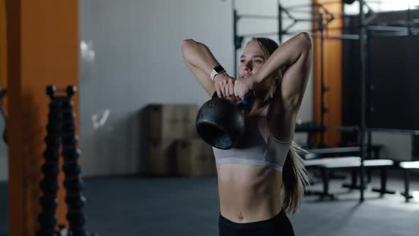 Athletic Woman in Gym Girl Lifts the Weight Muscle Training with Weights Crossfit