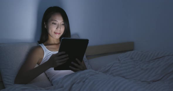 Woman use of tablet on bed