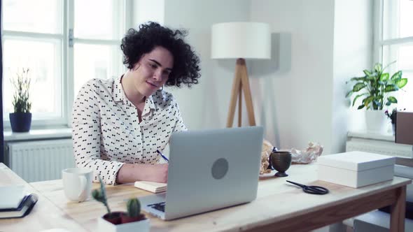 Young beautiful young woman working from home