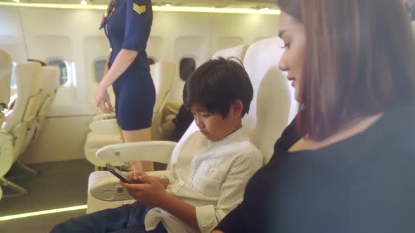 Cabin Crew Provide Service to Family in Airplane