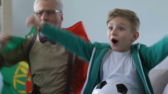 Old Man With Grandson Shouting During Tv Match Celebrating Portugal Team Victory