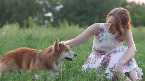 Smiling Woman With A Dog In The Field