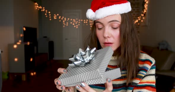 Displeased Woman Opening Christmas Gift