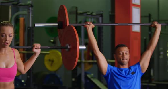 Man and woman exercising in a gym