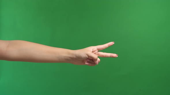 Woman's Hand Is Show Two Fingers Up On Green Screen Background