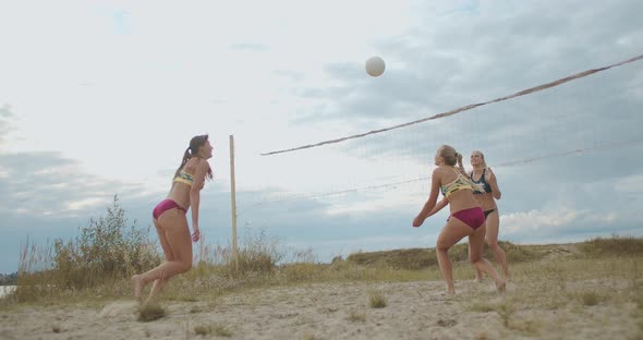 Friendly Match of Two Women Beach Volleyball Team, Ladies Are Playing on Court at Summer Day