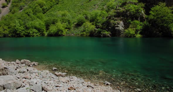 Small Mountain Lake of  blue color Urungach. Located in Uzbekistan, Central Asia. 2 out of 10