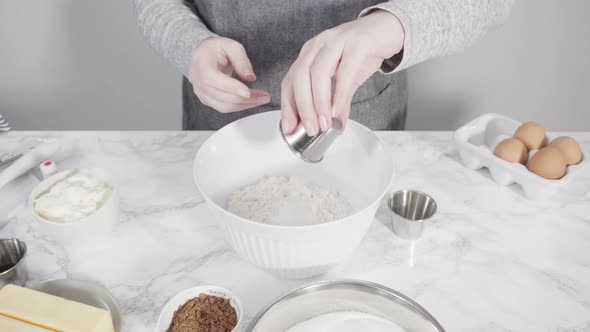 Step by step. Mixing dry ingredients to bake red velvet cupcakes.