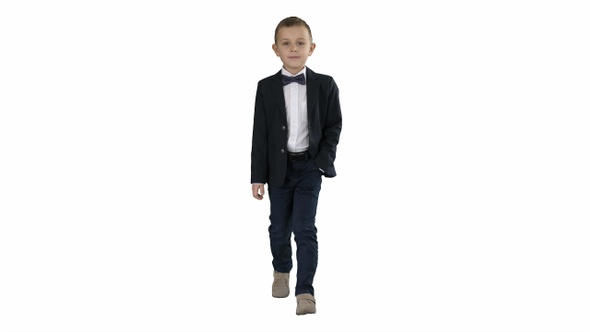 Boy in formal costume walking with a hand in pocket on