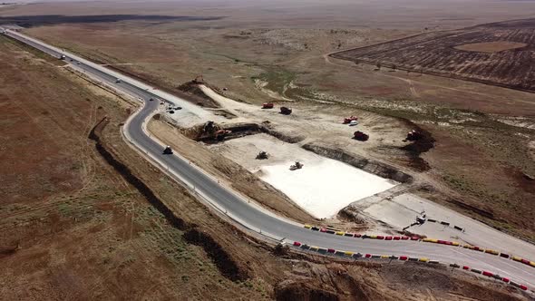 Aerial Road Constructions, Machinery and Mine Equipment Near Road on Sandy Surface