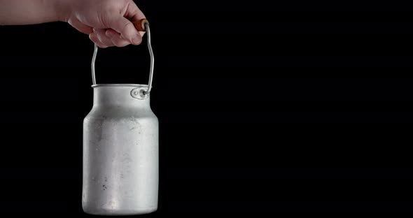 Male Hand Holding a Can of Milk.