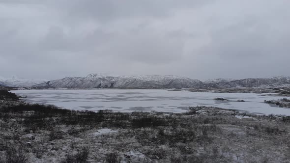 Frozen landscape in norway, a frozen lake in a valley