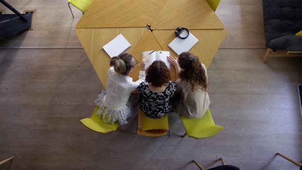 Female Students Discussing Great Ideas in Library Top View