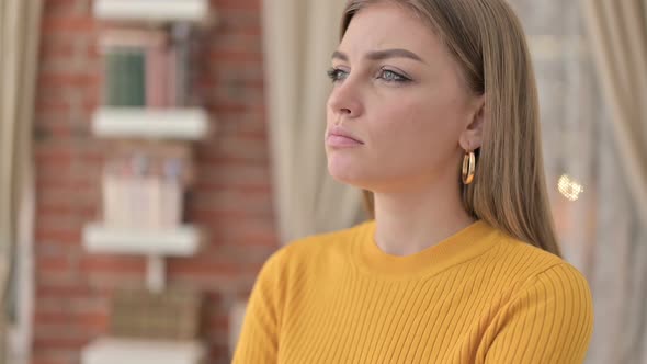 Portrait of Young Woman Thinking About Something