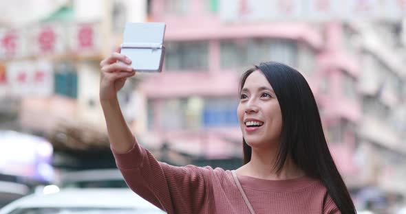 Woman take photo by camera in the city