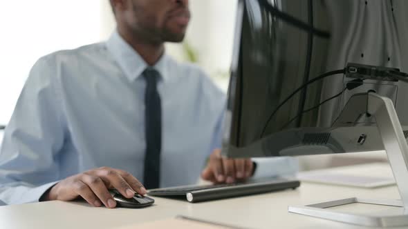 Businessman Working on Desktop Using Mouse and Keyboard